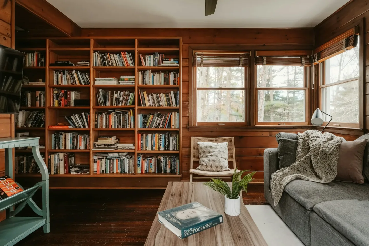 Cozy Living Room With Large Bookshelf And Comfortable Seating